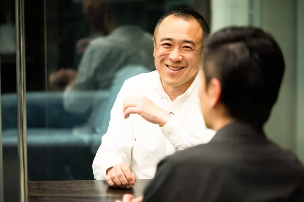 ALTはじまり：アイティプラスの野口さんが笑顔で話している様子。手前には溝口さんが写っていて、