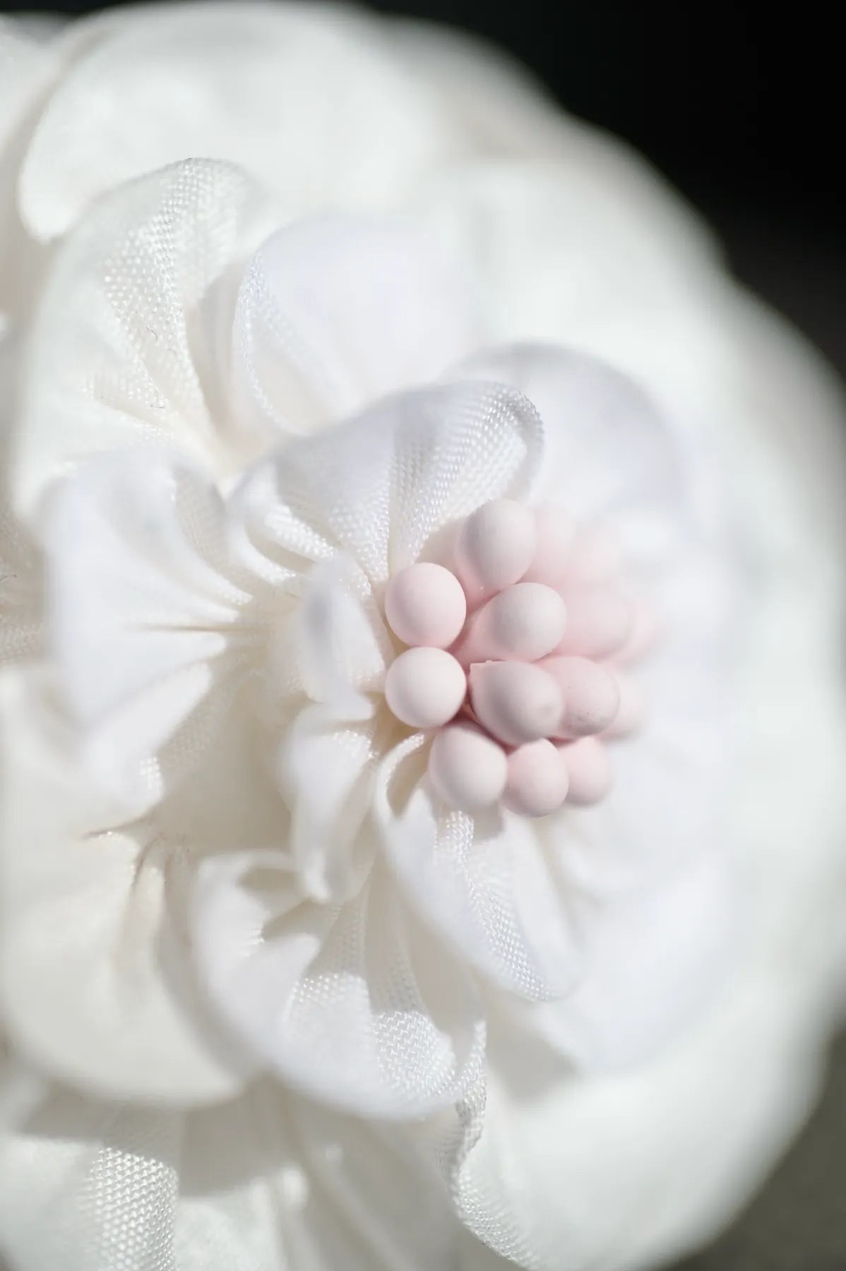 Tsumami flower made from layered white fabric petals