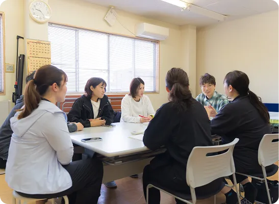 テーブルを囲んで研修や勉強会を行うスタッフたち