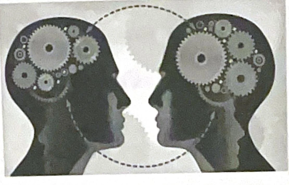 Illustration of two heads with gears inside, symbolizing the interconnectedness of thought or communication.