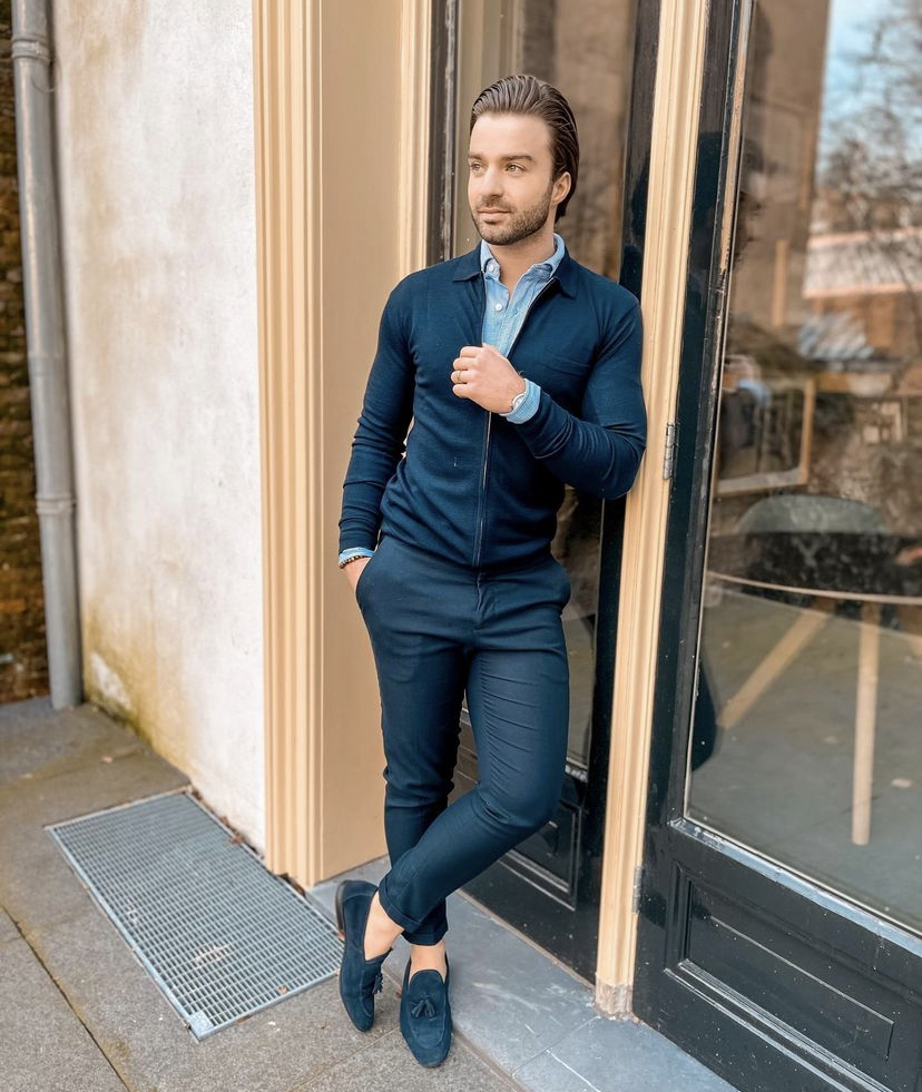 Looking elegant wearing a stripped blazer with a white shirt, beige  trousers and blue suede loafers