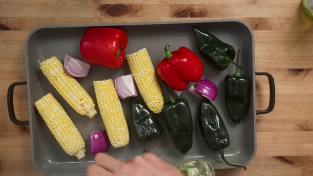Raw corn, peppers, and onions ready for grilling
