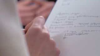 A person writing notes in a therapy session, symbolizing the intellectual engagement in understanding one's psyche.