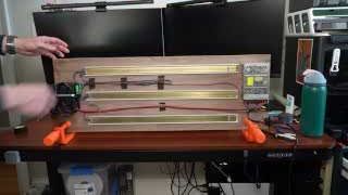 Adam showcasing the completed 45 modules on a wooden backing board with integrated electronics.