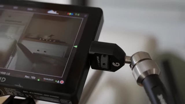 Close-up of monitor attachment on Bright Tangerine Titan Arm 2 with locating pins
