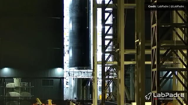 Ship 39 stacking in Megabay 2, showing pins and tiles being installed on sections between barrels during assembly.