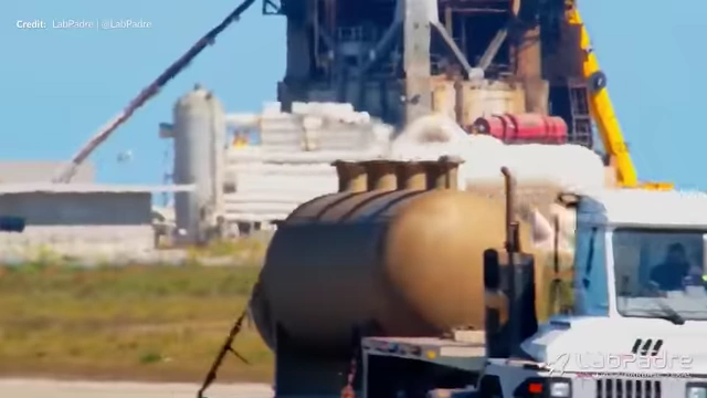 Obsolete Oxygen and Methane subcoolers with their top manifolds removed being rolled out from the tank farm.