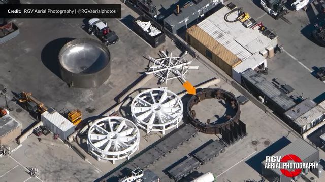 Aerial view of the scrap yard, showing old test tank 16 and a ship's static fire ring being dismantled.