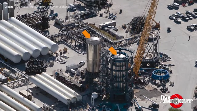 Workers disconnecting pistons from a test tank in the large can crusher at Masseys, potentially in preparation for replacement.