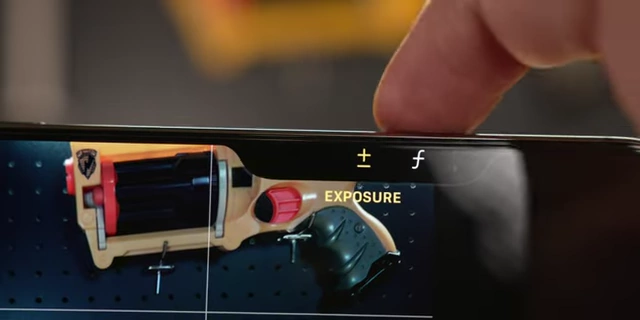 Using the camera control button on the iPhone to adjust settings