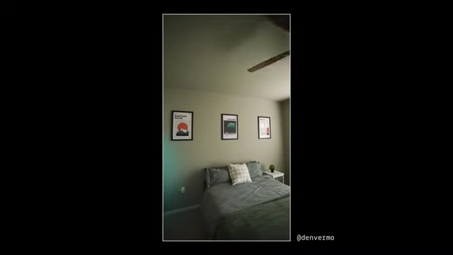 A bedroom wall decorated with framed minimalist movie posters.
