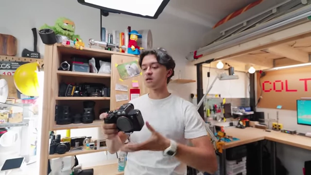 Colt holding his Sony A7S3 camera, his primary gear for YouTube and client work.