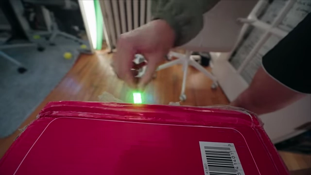 A Lego lightsaber meticulously cutting tape to open a box, demonstrating a unique creative effort.