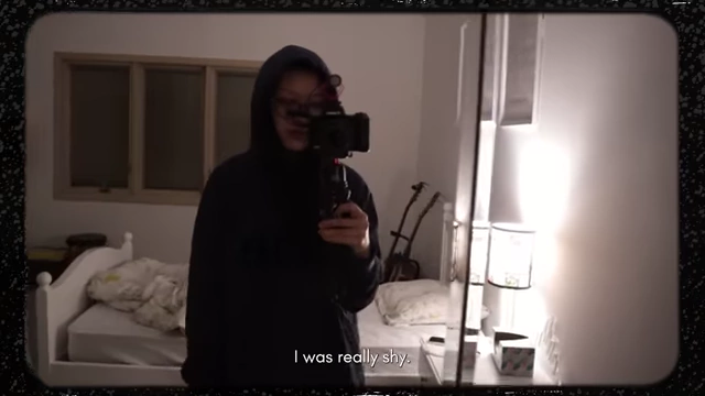 The speaker taking a shy selfie in a mirror.