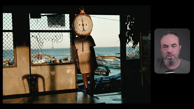 A dangling scale with a person silhouetted in the background against a bright sea, demonstrating how a photographer frames a subject and decides what to include and exclude.