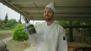 A bottle of high-proof Everclear, used as food-grade ethanol, held by the host.