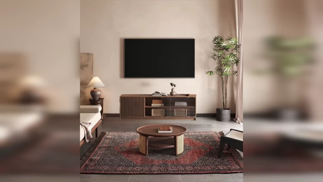 A living room with a large TV mounted above a console table that is significantly narrower than the television, creating visual imbalance.