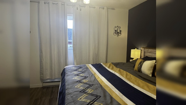 A bedroom with severely wrinkled white curtains, illustrating how creased fabric can detract from the overall appearance.