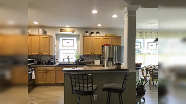 A kitchen featuring wall cabinets that stop well short of the ceiling, creating an empty, dusty gap above them.