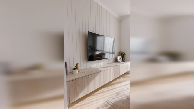 A modern living room with a TV mounted on a light wood paneled wall above a long, matching media console that extends well beyond the TV's width, creating a cohesive feature wall.
