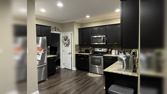 Another kitchen with cabinets that do not reach the ceiling, leaving a large, dusty gap above.