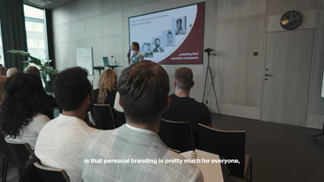 A presenter discussing the universal benefit of personal branding at the Tai Lopez mastermind
