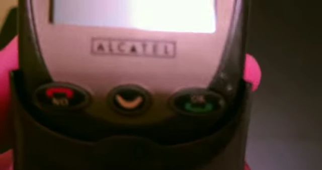 A close-up of an Alcatel mobile phone, featuring its keypad and screen, representing the devices that utilize smart card technology like