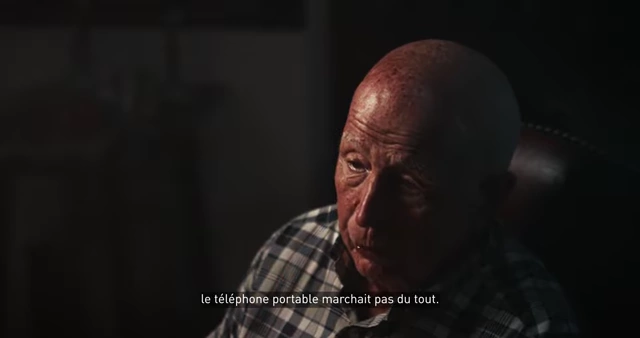 An older Marc Lassus speaking in an interview, with subtitles stating his