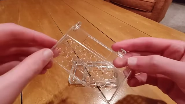 A clear resin casing part, showcasing its transparency and quality