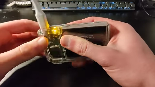 The amber charging indicator lit while the device is plugged in via USB-C