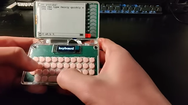 Hands demonstrating typing on the custom-designed, quiet keyboard
