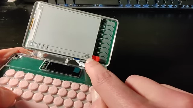 The small OLED screen displaying FN and Shift indicators