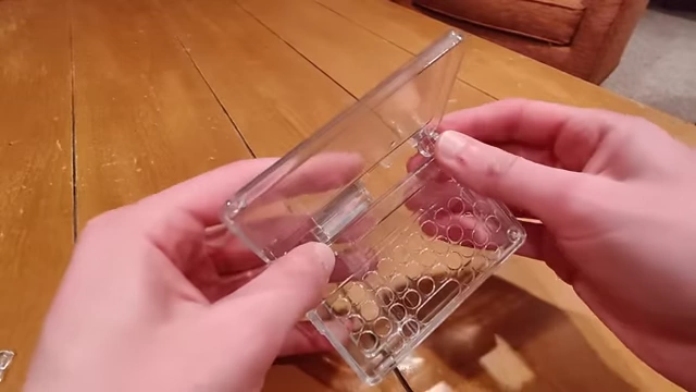 A clear resin hinge component demonstrating its fit