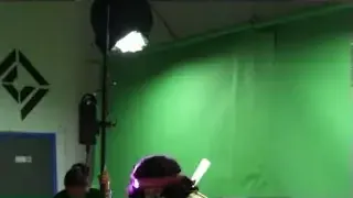 A green screen setup with uneven lighting and shadows, illustrating a common problem.