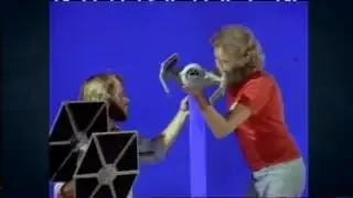 Actors and a model spaceship against a blue screen, showing the setup for early chroma keying in "Star Wars."