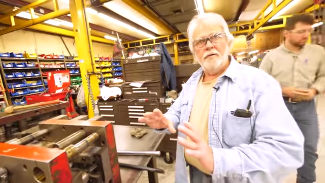 Roger, a tool and die expert, teaching and explaining concepts in a workshop.