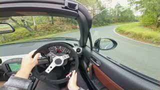Hands on the steering wheel during a turn, illustrating steady throttle input after braking