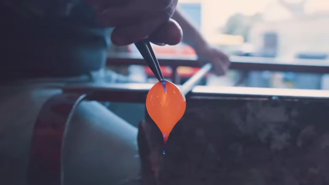 A glassblower shaping molten glass, symbolizing history as 'molten glass'