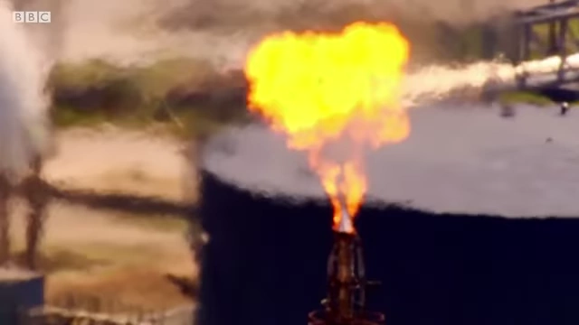 A flare stack burning gas at an industrial facility