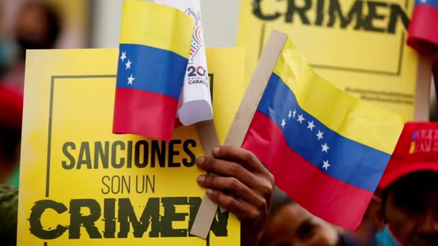 A protest sign in Spanish, 'Sanciones son un crimen' (Sanctions are a crime)