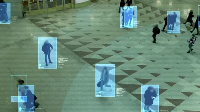 A simulated surveillance camera view with facial recognition highlights