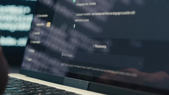 A person typing on a laptop, showing a ChatGPT interface