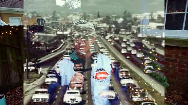 A distorted image of a busy highway superimposed over the speaker