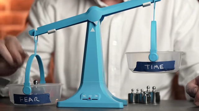 Scales showing "FEAR" vs "TIME"