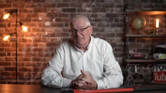 Speaker discussing traditional education, with math formulas overlaid