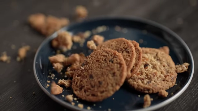 Crumbling cookies on a plate, illustrating money diminishing with too much handling