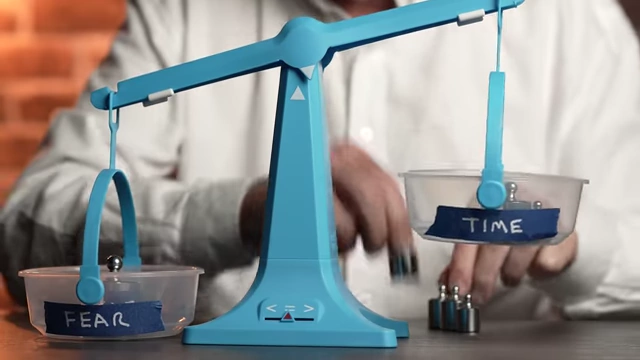 A hand placing additional weights onto the "TIME" side of a scale, showing time as a strong advantage