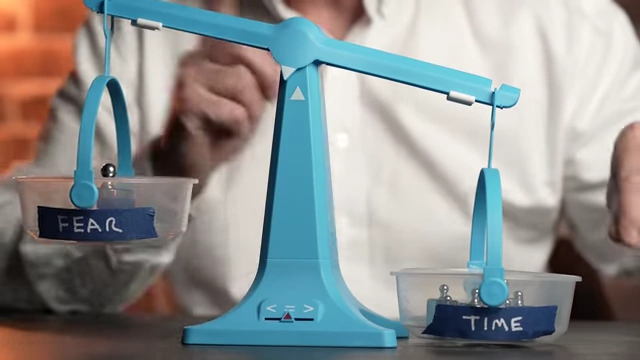 A set of scales where "TIME" on the right clearly outweighs "FEAR" on the left