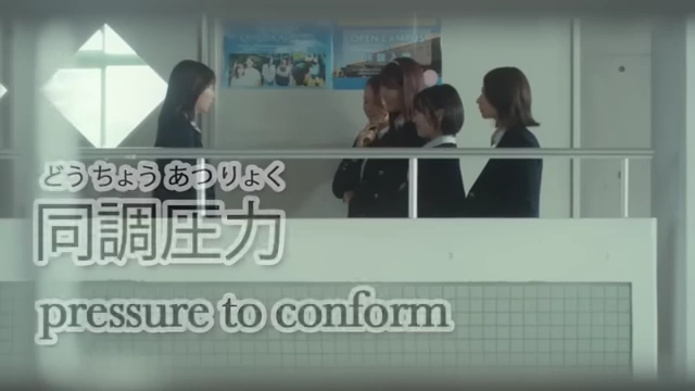 Japanese schoolgirls are depicted in a classroom, with text on screen stating "pressure to conform," illustrating a significant societal pressure.