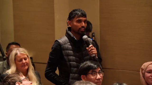 A student asking a thoughtful question during the Q&A session.